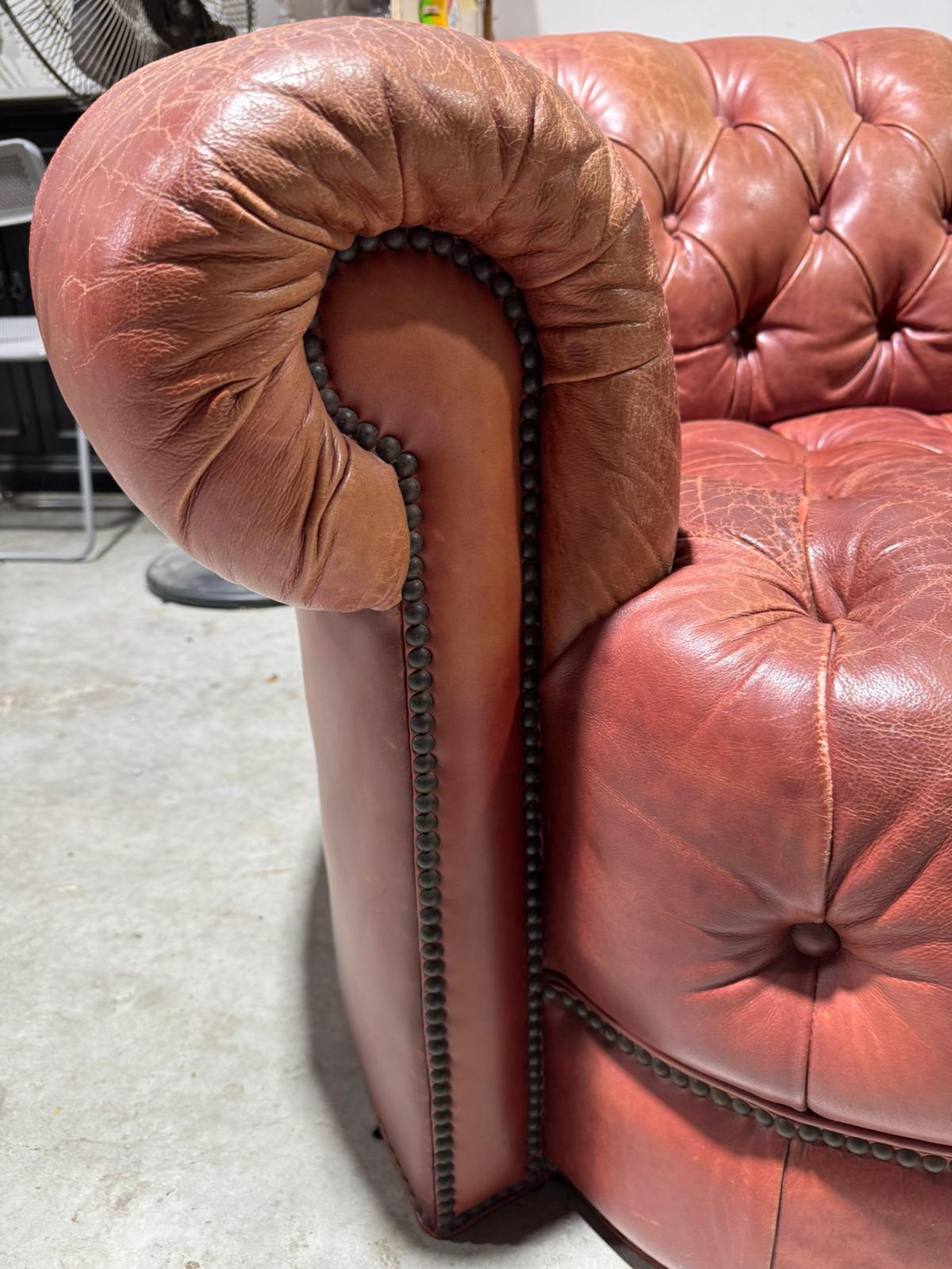 Close-up detail of Chesterfield sofa arm with nailhead trim