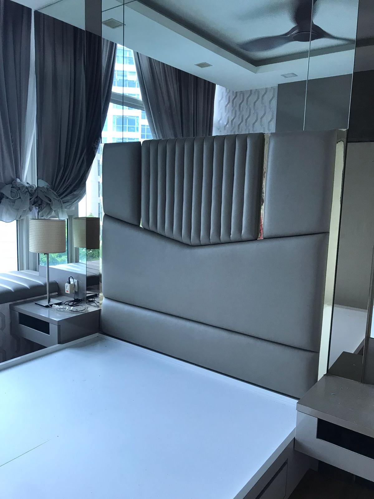 Grey channel-tufted upholstered headboard with vertical ribbing in modern bedroom